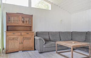 a living room with a couch and a wooden table at 2 Bedroom Cozy Home In Vallavik in Bu +9 photos