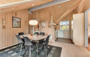 a dining room with a table and chairs at Holiday Home Kirksvej Hvide Sande Iv in Bjerregård +20 photos