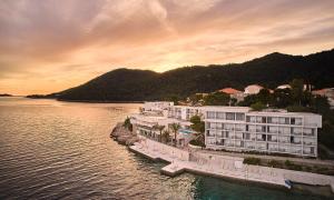 a large building in the middle of a body of water at Aminess Lume Hotel in Brna