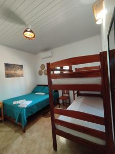 a bedroom with a bunk bed and a ladder toweredwered at Point lanabarra in Amontada
