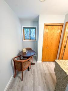 a room with a table and a wooden door at Lake Bluff Inn and Suites in South Haven