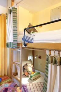 A bed or beds in a room at Flotsam and Jetsam Artist Beach Hostel