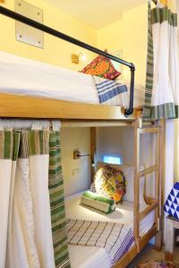 A bed or beds in a room at Flotsam and Jetsam Artist Beach Hostel