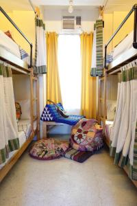 A bed or beds in a room at Flotsam and Jetsam Artist Beach Hostel