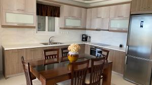 a kitchen with a dining table and a refrigerator at Villa Christina Luxury in Vouliagmeni Lake +50 photos