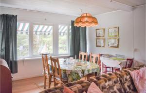 a dining room with a table and a couch at Holiday Home Yngsjö 49 in Yngsjö