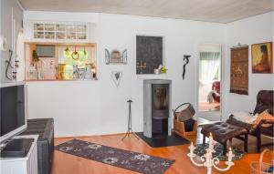 a living room with a fireplace and a couch at Holiday Home Yngsjö 49 in Yngsjö +21 photos
