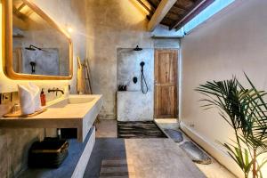 a bathroom with a sink and a shower at Villa Manouch in Nusa Lembongan +18 photos