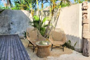 two chairs and a table on a patio at Villa Manouch in Nusa Lembongan