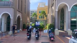 a group of motorcycles parked outside of a building at Arcadia beach 网红水系公寓一房 Nice view 专业的健身房 桑拿 中心位置 交通便利 Smart tv WiFi in Pattaya South