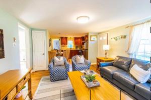 a living room with a couch and a table at Waterfront Cape Cod Home in Dennis Port