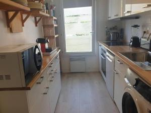 a kitchen with a sink and a dishwasher at Vallon des auffes - proche mer in Marseille
