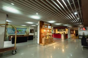 a lobby with a shopping mall with a store at Kyriad Haka Makassar in Makassar