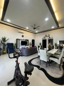 a living room with a bike parked in a living room at Merang Jetty Homestay in Baroh Pahlawan