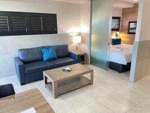 a living room with a couch and a bed at Honeysuckle Executive Apartments in Newcastle +125 photos