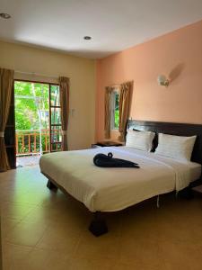 a large bed with a black robe on top of it at Boonya Resort Koh Chang in Ko Chang +162 photos