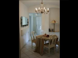 a dining room with a table and chairs and a chandelier at Apartment Hermine in Görlitz