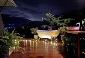 a bath tub sitting on a patio with lights at Camp Mai Mee Chue in Pong Yaeng