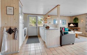 a kitchen with a couch and a table in a room at Holiday Home Ringvejen Vi Denmark in Bolilmark +19 photos