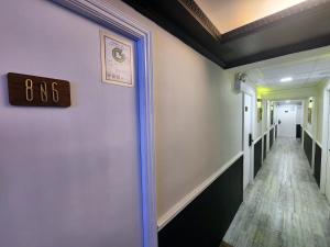 a hallway with a clock on the wall at Pillows CoLiving in Hong Kong