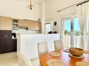 a kitchen and dining room with a wooden table and chairs at Apartment Elaine's View in Umag