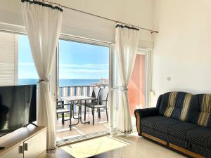 a living room with a couch and a view of the ocean at Apartment Elaine's View in Umag
