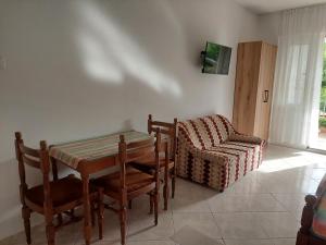a dining room with a table and a chair at Apartments Ivana in Ulcinj +30 photos