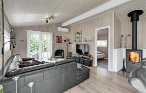 a living room with a couch and a fireplace at Holiday Home Oksbøl - 06 in Oksbøl