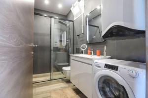 a bathroom with a washing machine and a toilet at Vp & Lo 1 Residence in Corfu