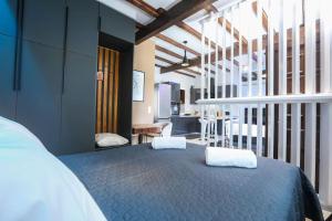 a bedroom with a bed with two white towels on it at Vp & Lo 1 Residence in Corfu