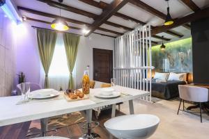 a living room with a white table and chairs at Vp & Lo 1 Residence in Corfu