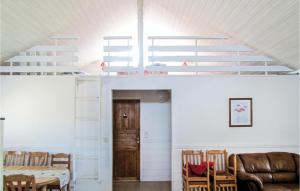 a room with white walls and a staircase with a table and chairs at 5 Bedroom Lovely Home In Kleppe in Orre