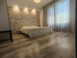 a bedroom with a bed and a large window at 4 RENT-Apt 3 camere Tichete,Factură in Constanţa
