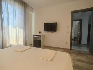 a bedroom with a bed and a tv on the wall at 4 RENT-Apt 3 camere Tichete,Factură in Constanţa
