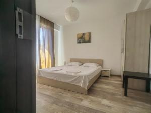 a bedroom with a white bed and a window at 4 RENT-Apt 3 camere Tichete,Factură in Constanţa +6 photos