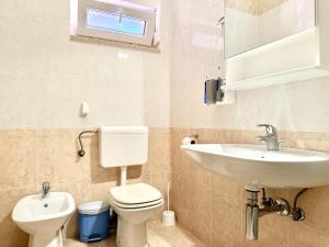 a bathroom with a toilet and a sink at Apartment Elaine's View in Umag +24 photos