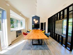 a large dining room with a wooden table and chairs at Villa By Nature in Yawatano +56 photos