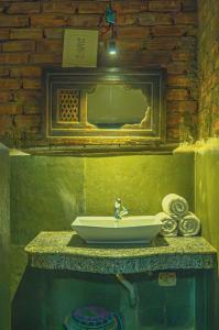 a bathroom with a sink and a mirror at Open Road Hostel and Cafe in Jaisalmer +88 photos