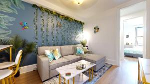 a living room with a couch and a table at 15 Minutes to NYC - Garden Street Retreat in Hoboken