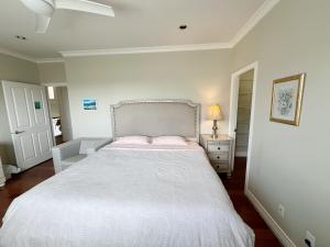 a bedroom with a large white bed with pink pillows at A quiet independent entrance suite on second floors with private bathroom close to YVR in Richmond