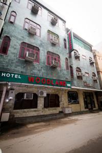 a building with a hotel woodland on the side of it at Hotel Woodland Deluxe in New Delhi