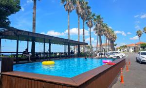 a large swimming pool with a yellow ball and frisbees at Benikea Hotel Jeju in Jeju