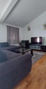 a living room with a couch and a table at I&A apartman in Kaštela +11 photos
