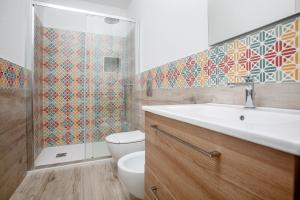 a bathroom with a toilet and a sink and a shower at TrèSOR in Santa Teresa Gallura