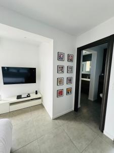 a living room with a flat screen tv on a wall at Casa La Vista in Bastia