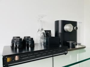 a black shelf with cups and a blender on it at Casa La Vista in Bastia