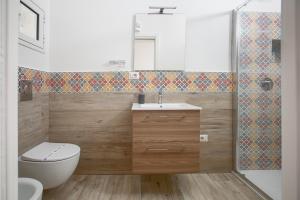 a bathroom with a toilet and a sink and a shower at TrèSOR in Santa Teresa Gallura