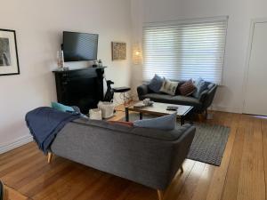 a living room with a couch and a fireplace at 83 Magnolia Avenue in Mildura