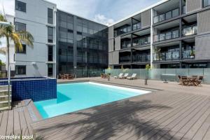 an exterior view of a building with a swimming pool at The Lookout - Mount Maunganui in Mount Maunganui