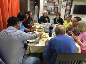 a group of people sitting around a table eating food at Swat hilltop resort in Swat
